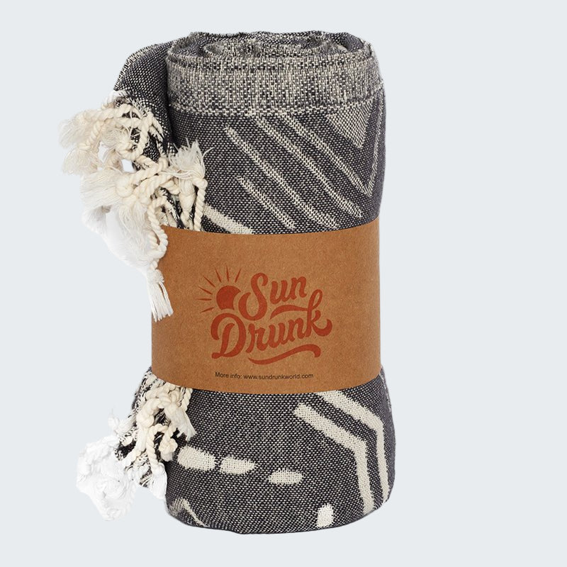 Folded blanket with a 'Sun Drunk' label on a white background
