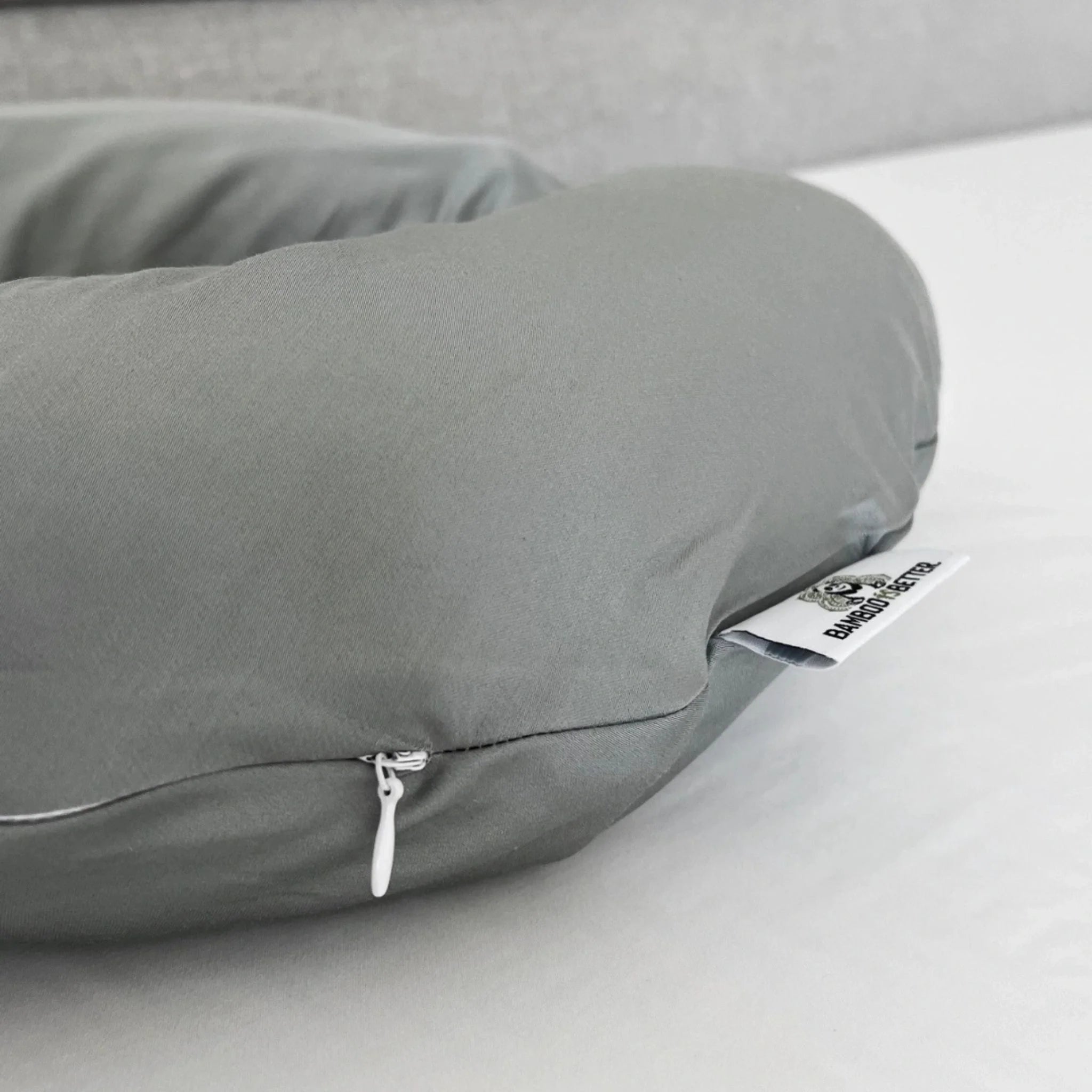 Gray pillow with a zipper on a light gray background