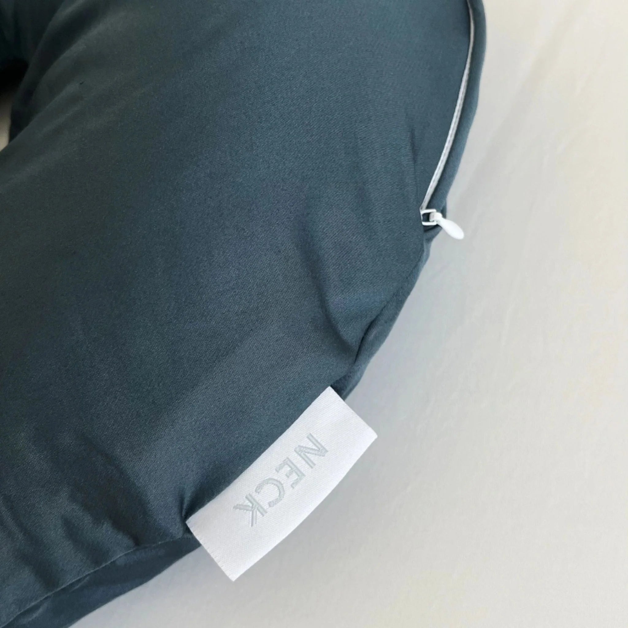 Neck pillow with a label on a light gray background