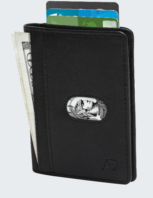 Black wallet with a silver emblem holding money and cards on a white background