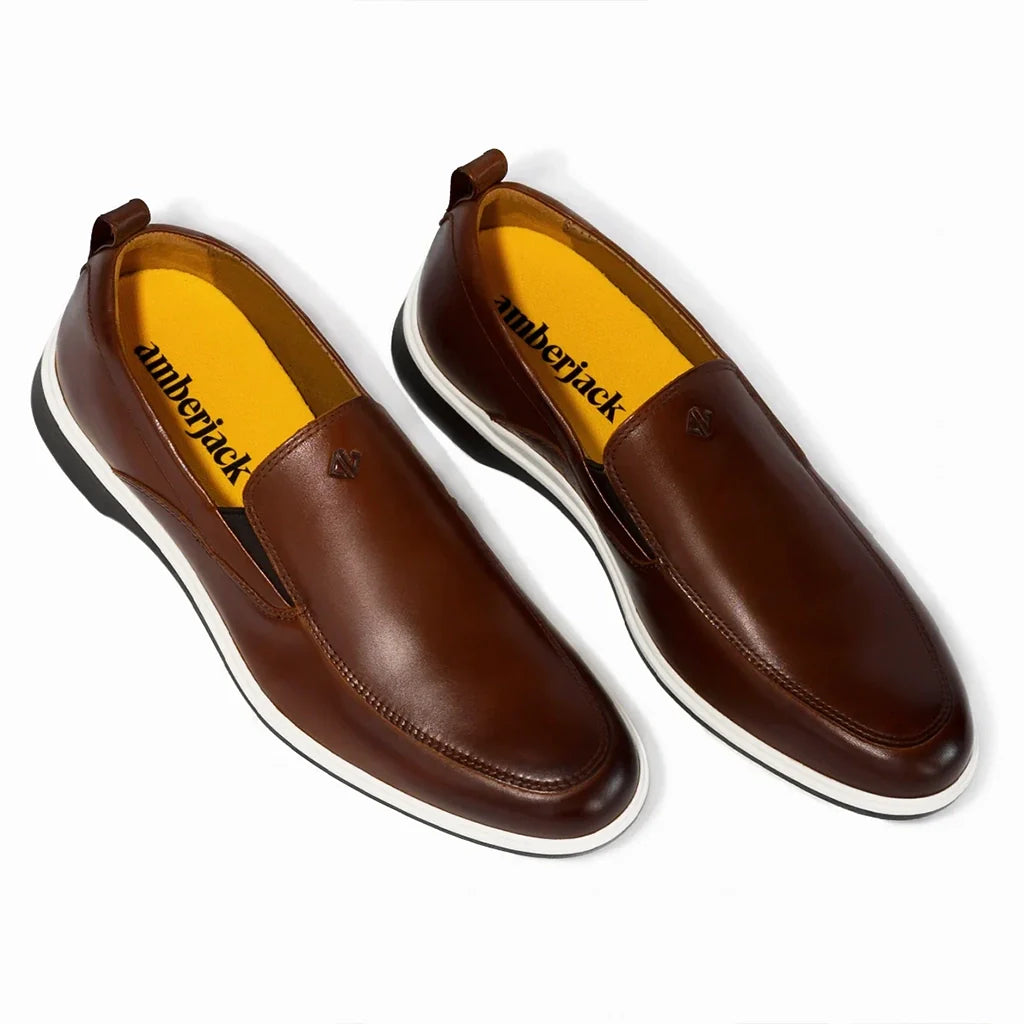 Brown leather shoes with yellow lining on a white background