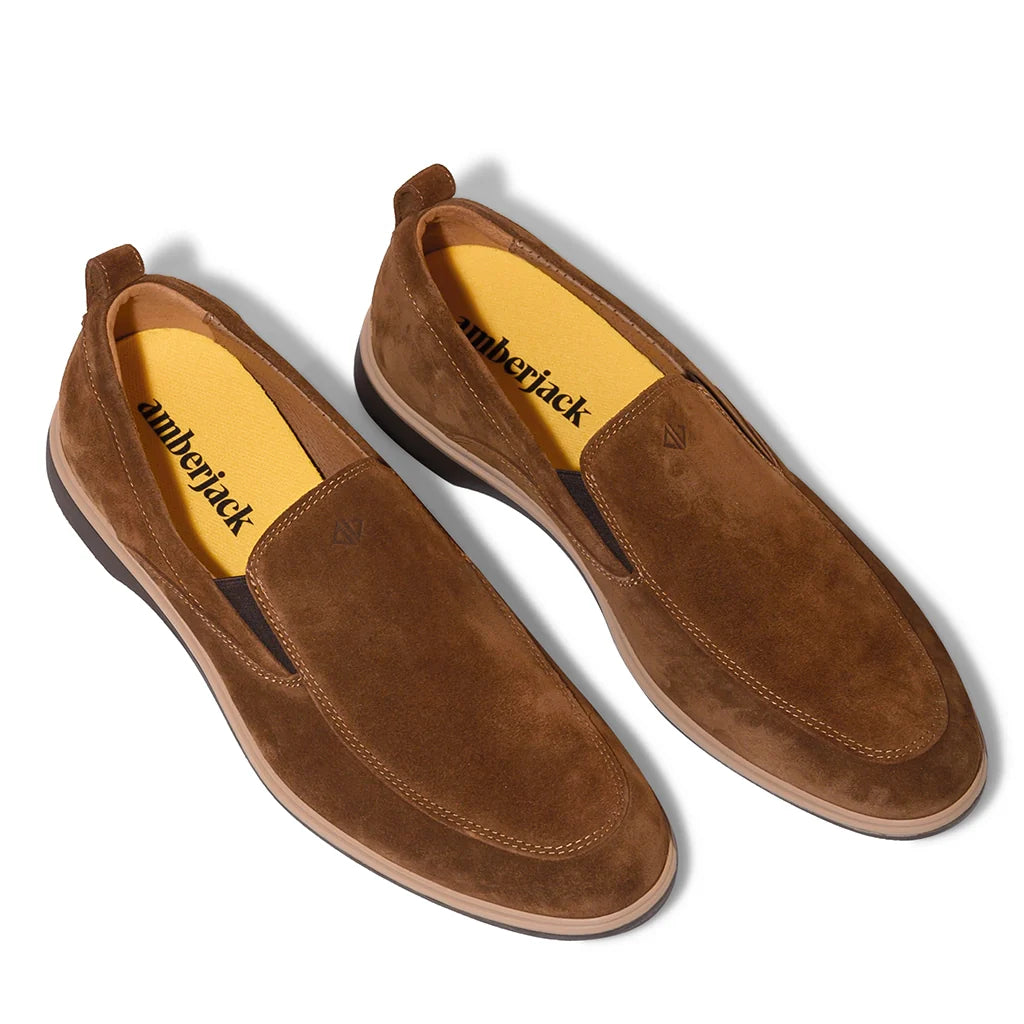Pair of brown suede shoes with ' lumberjack' branding on a white background