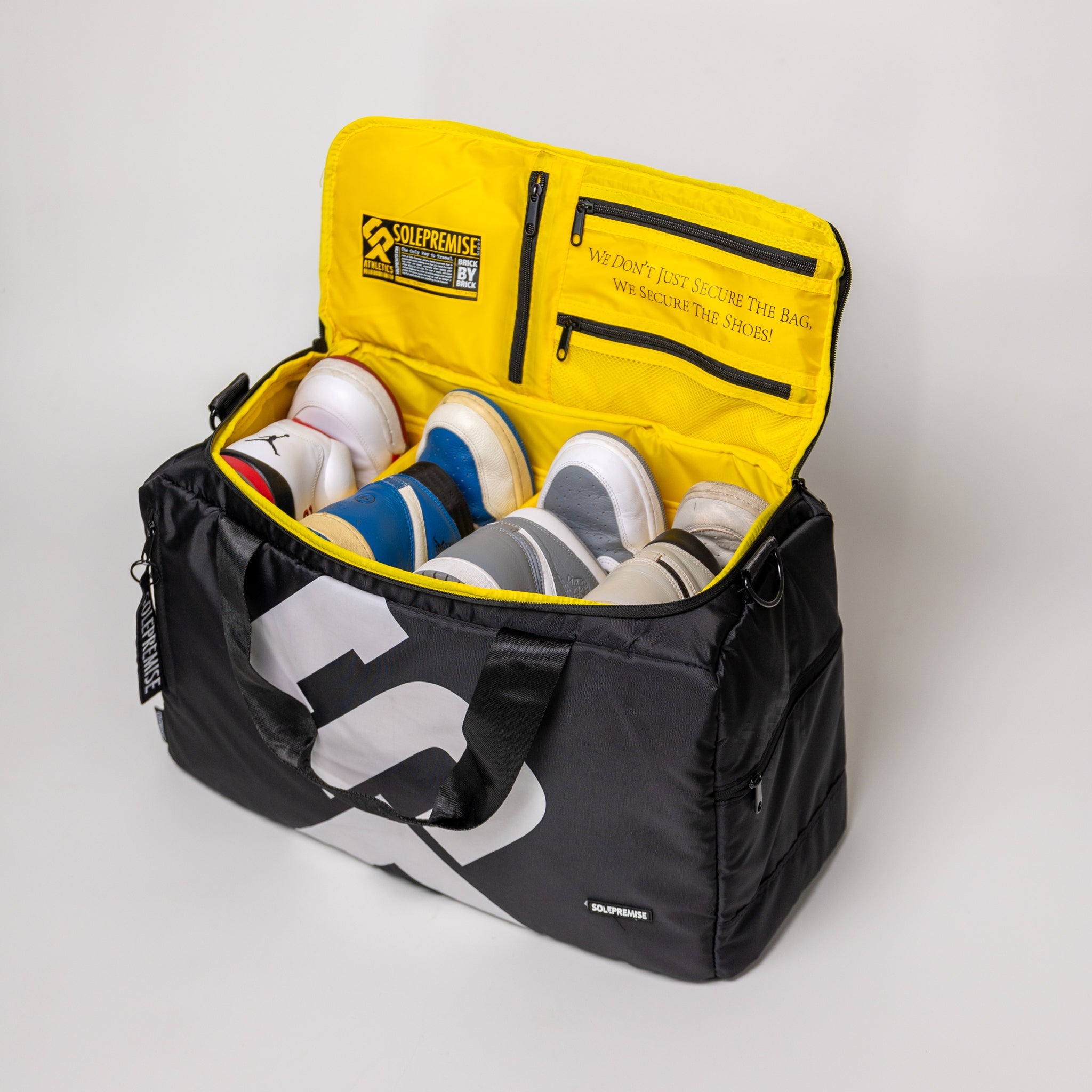 Black and yellow bag with shoes inside on a white background