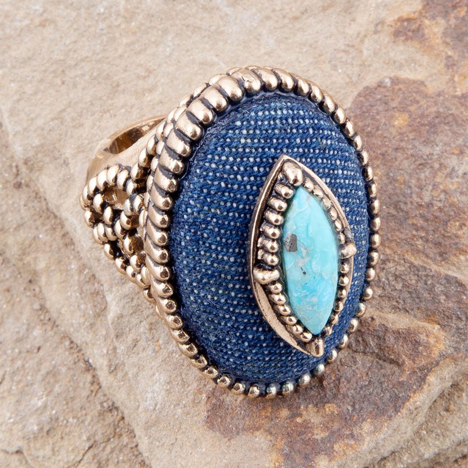 Blue ring with turquoise stone on a stone surface