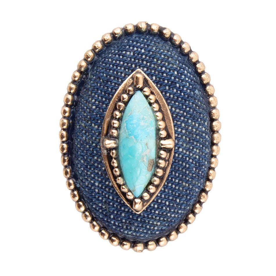 Ring with blue stone and gold accents on a white background