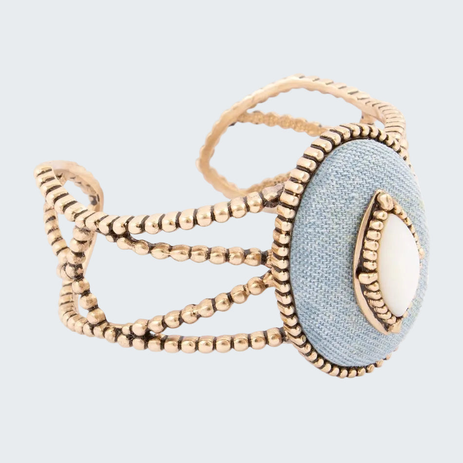 Gold and light blue bracelet on a white background