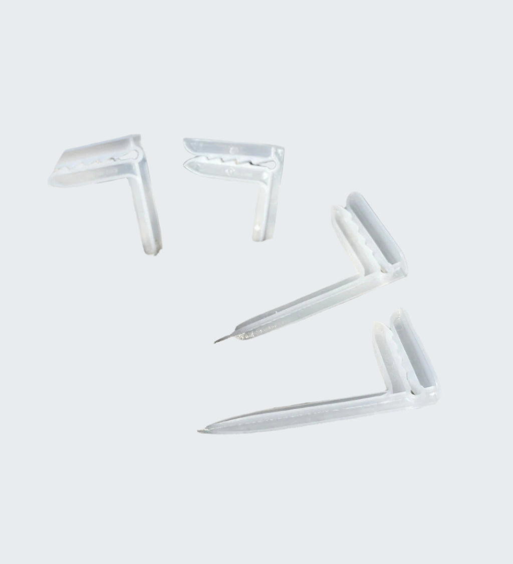 Clear white anchor on sandy beach with ocean waves