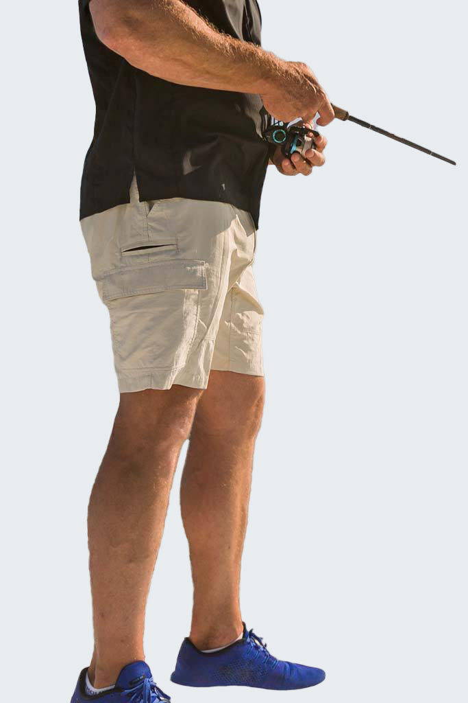 Person wearing beige shorts and a black sleeveless shirt, holding a fishing rod on a white background