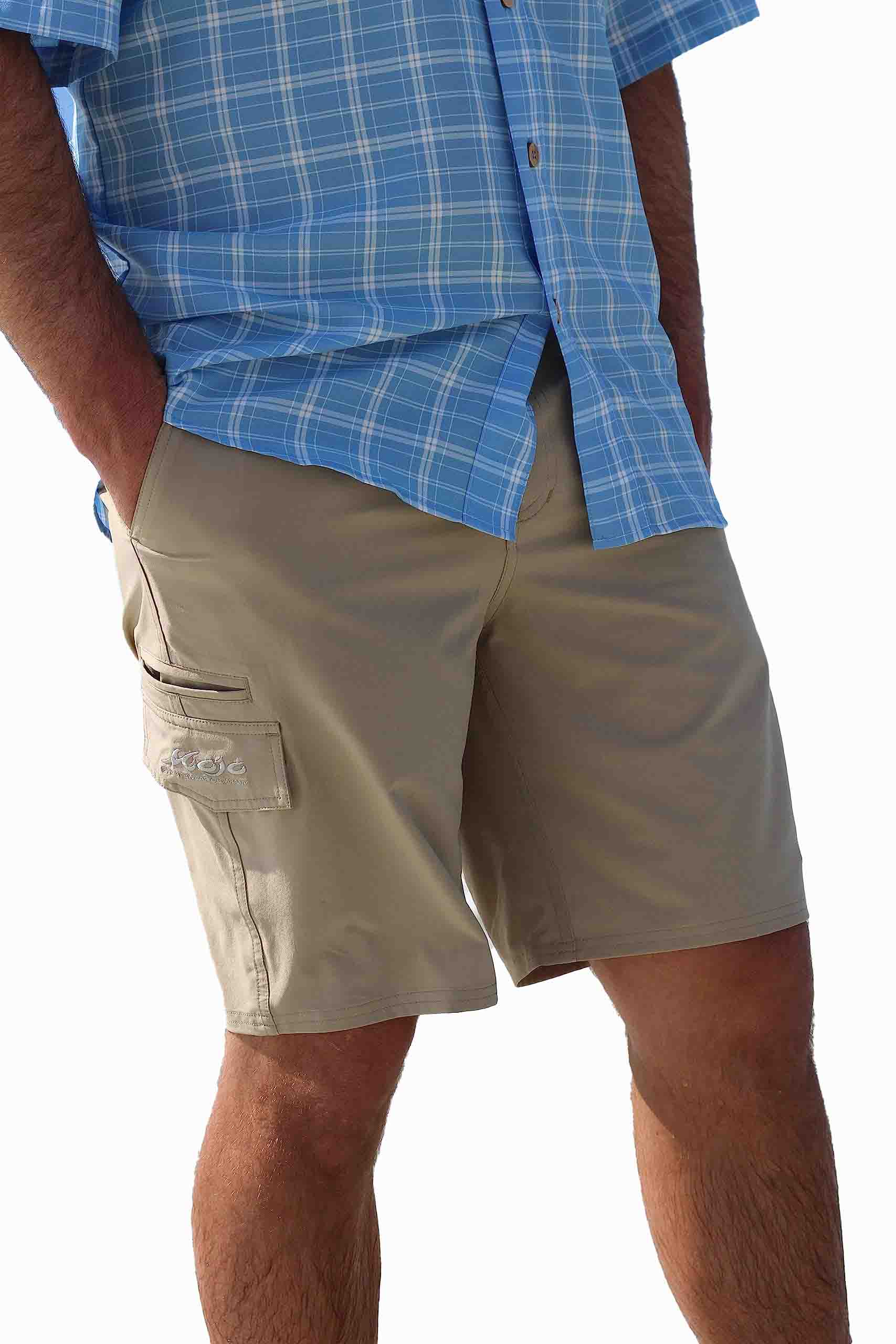 Person wearing beige shorts and a blue plaid shirt on a white background