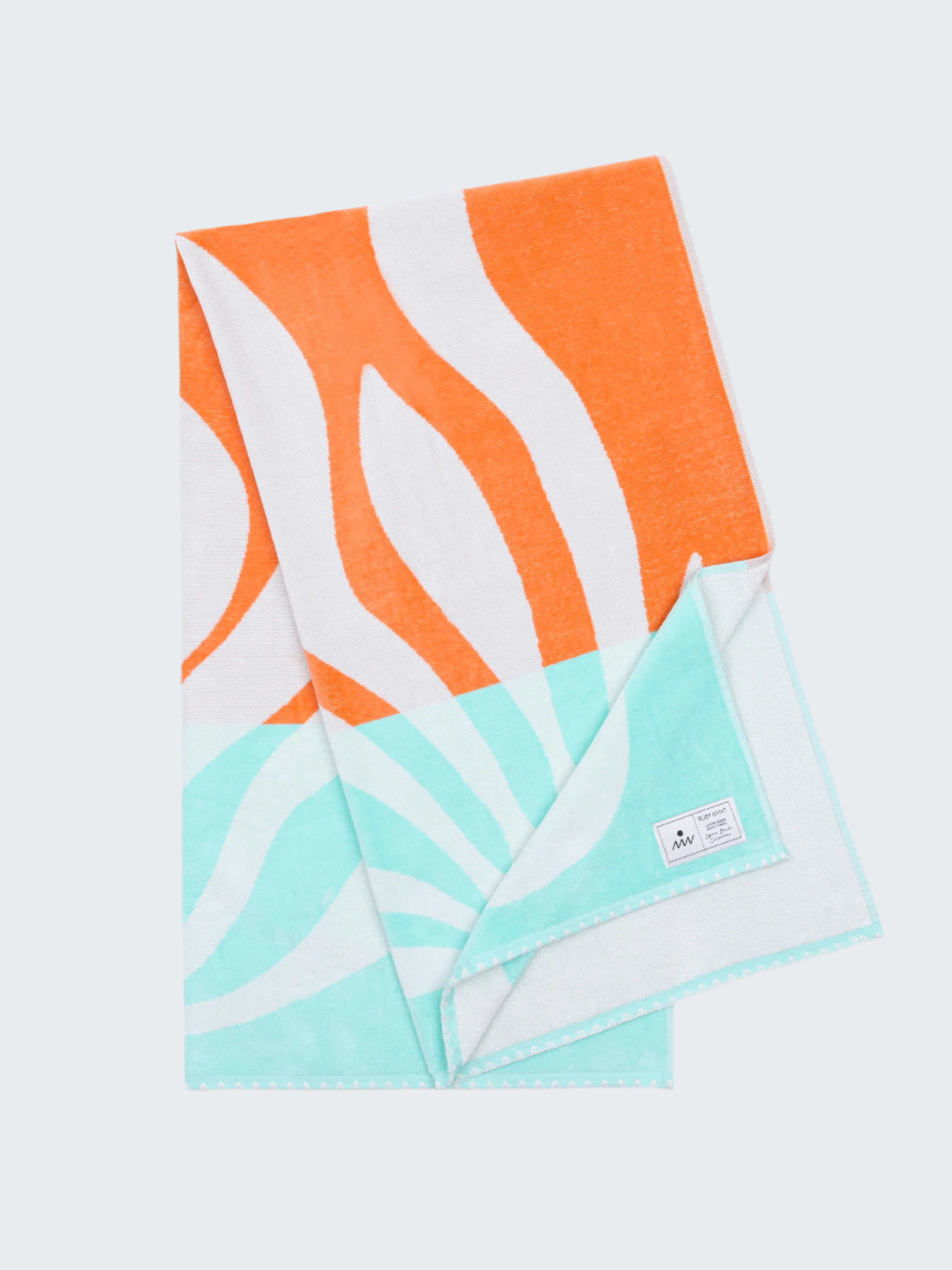 Towel with orange, white, and turquoise pattern on a white background