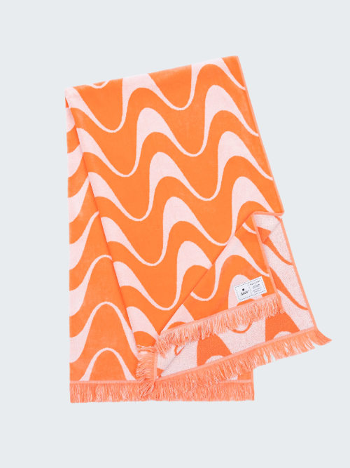 Orange and pink wavy patterned towel on a white background