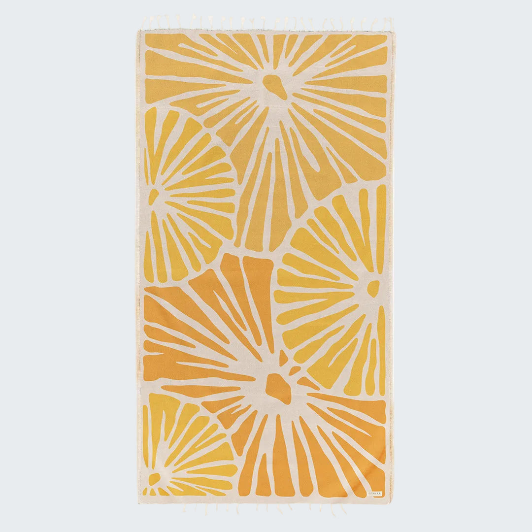 Yellow and white patterned towel on a white background