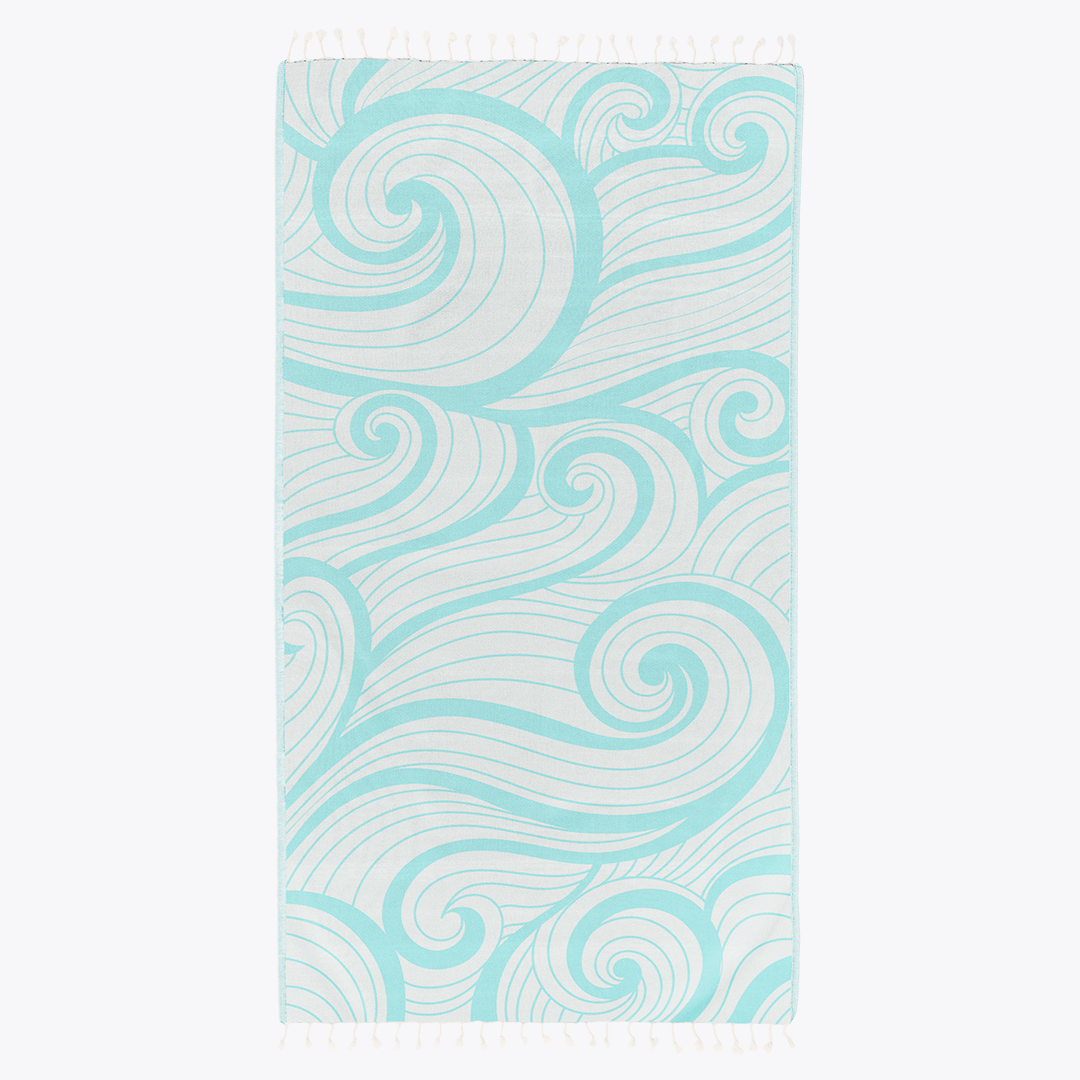 Teal and white patterned towel on a white background