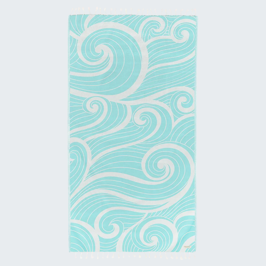 Teal and white patterned towel on a white background