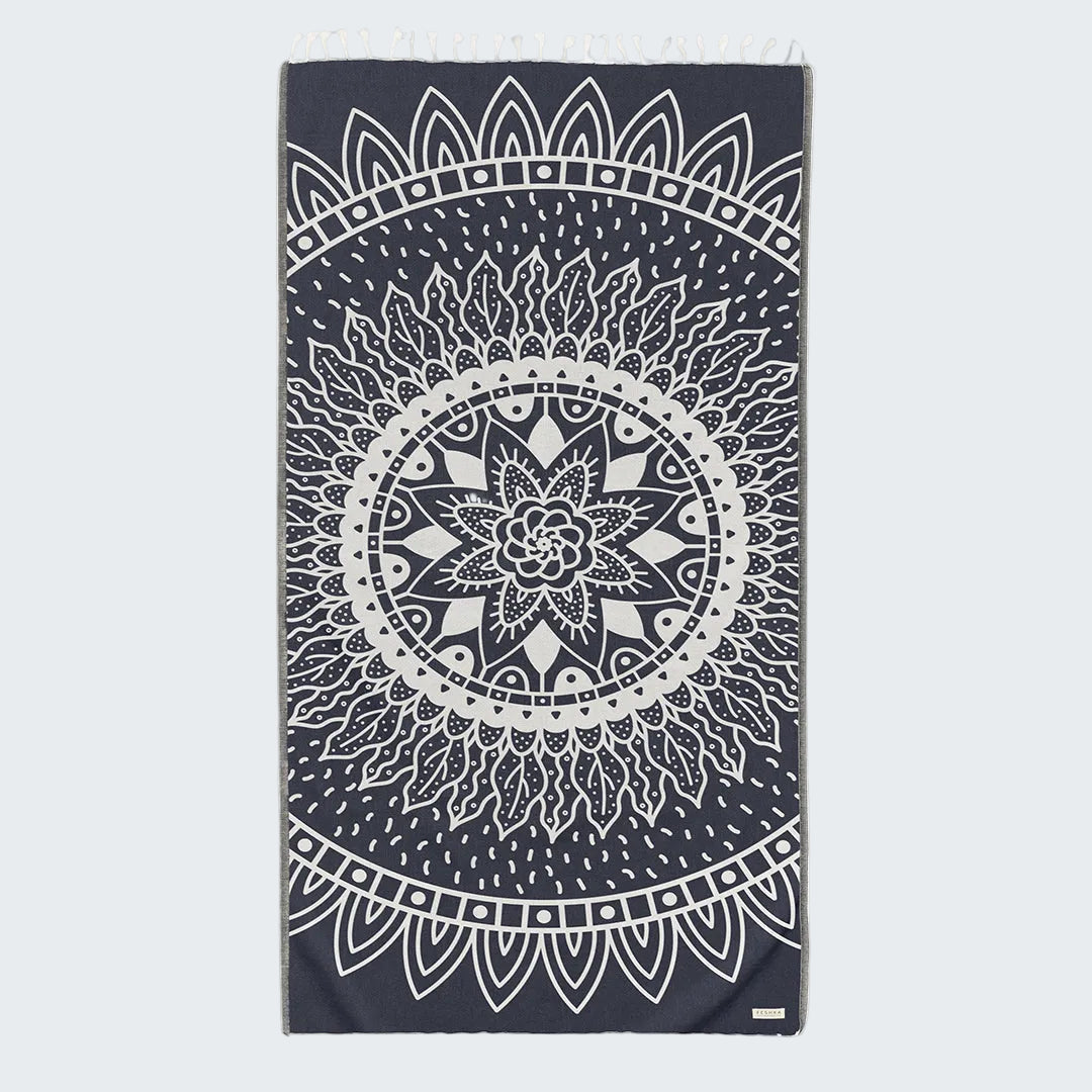Black towel with white mandala design on a white background