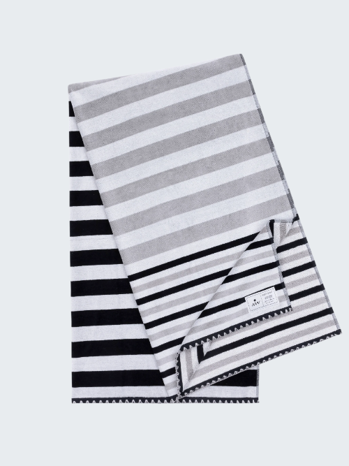 Striped towel with black, white, and gray stripes on a white background