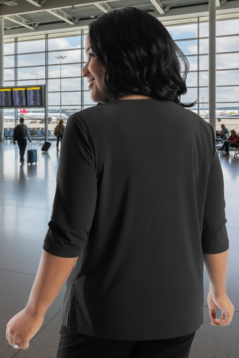 Woman wearing a black long-sleeve top on a white background