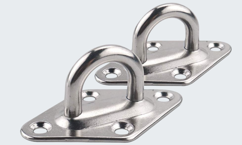 Two metal hooks on plates with holes on a white background