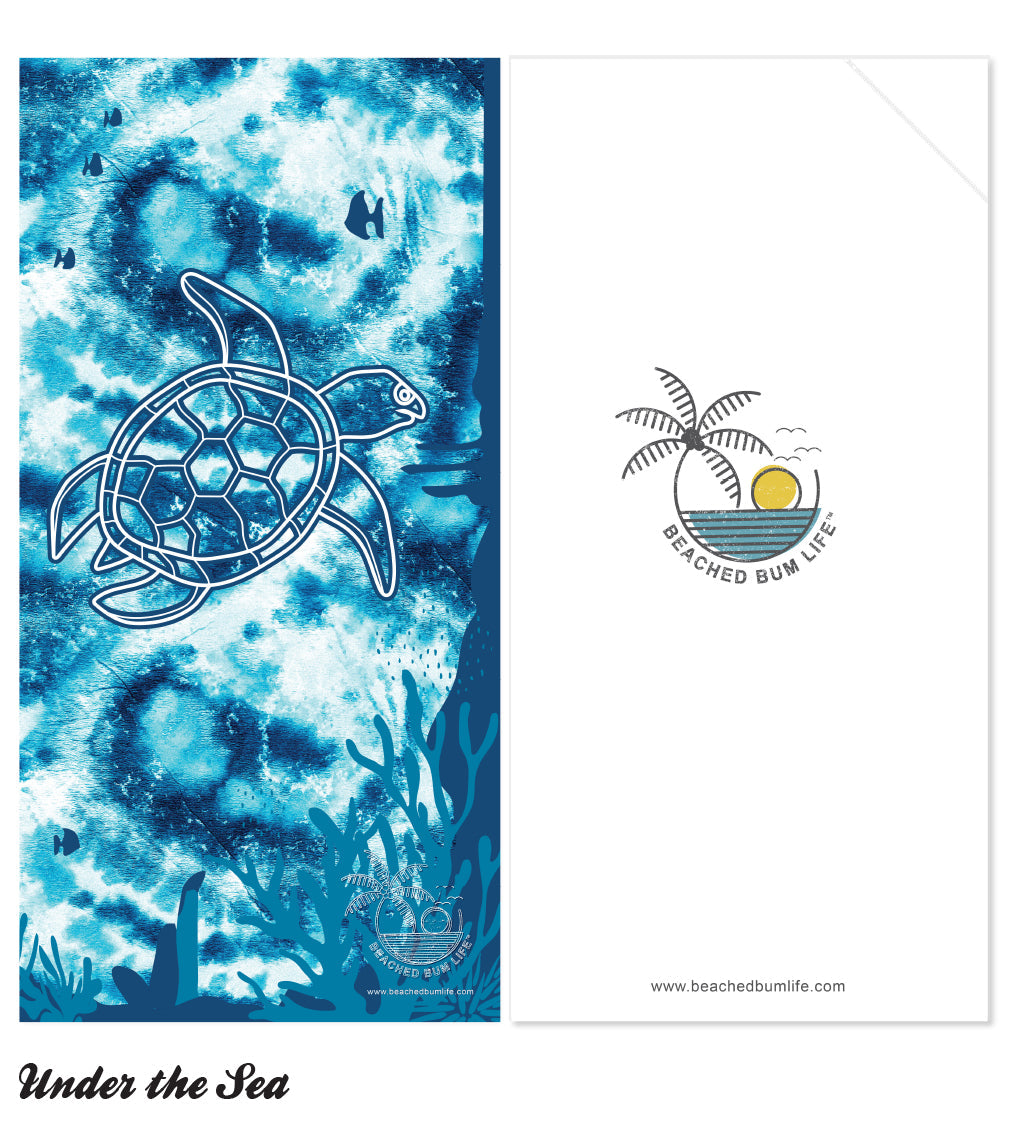 Towel with turtle design and 'Beached Bum Life' logo on a white background