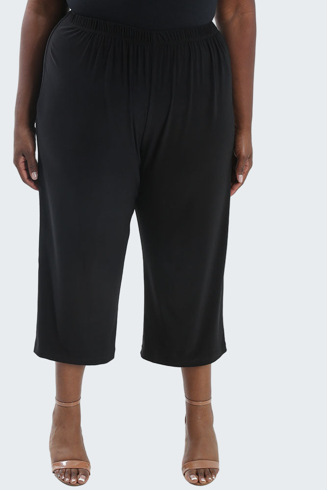 Black wide-leg pants worn by a person on a white background
