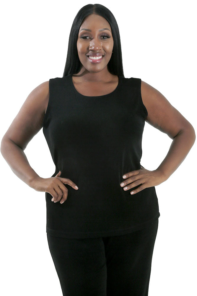 Woman wearing a black sleeveless top and pants on a white background