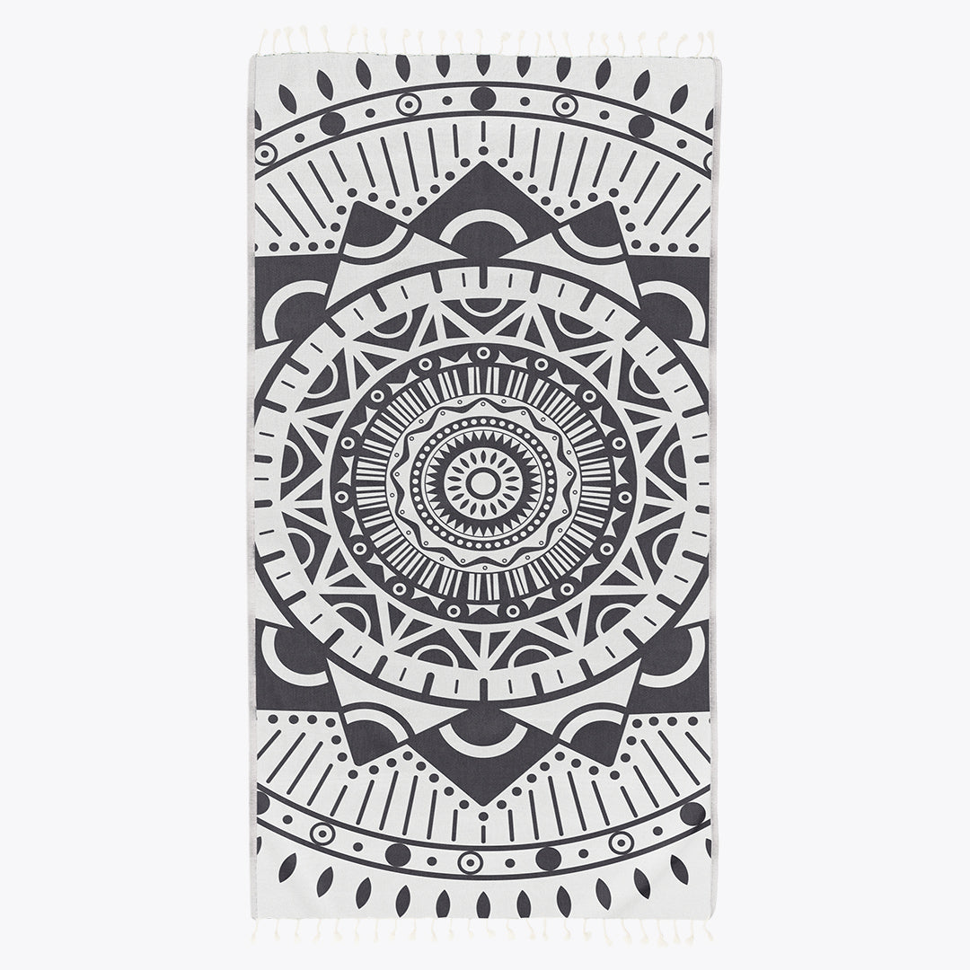 Black and white mandala patterned towel on a white background