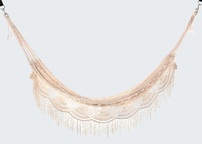 Beige hammock swing with fringe on a white background