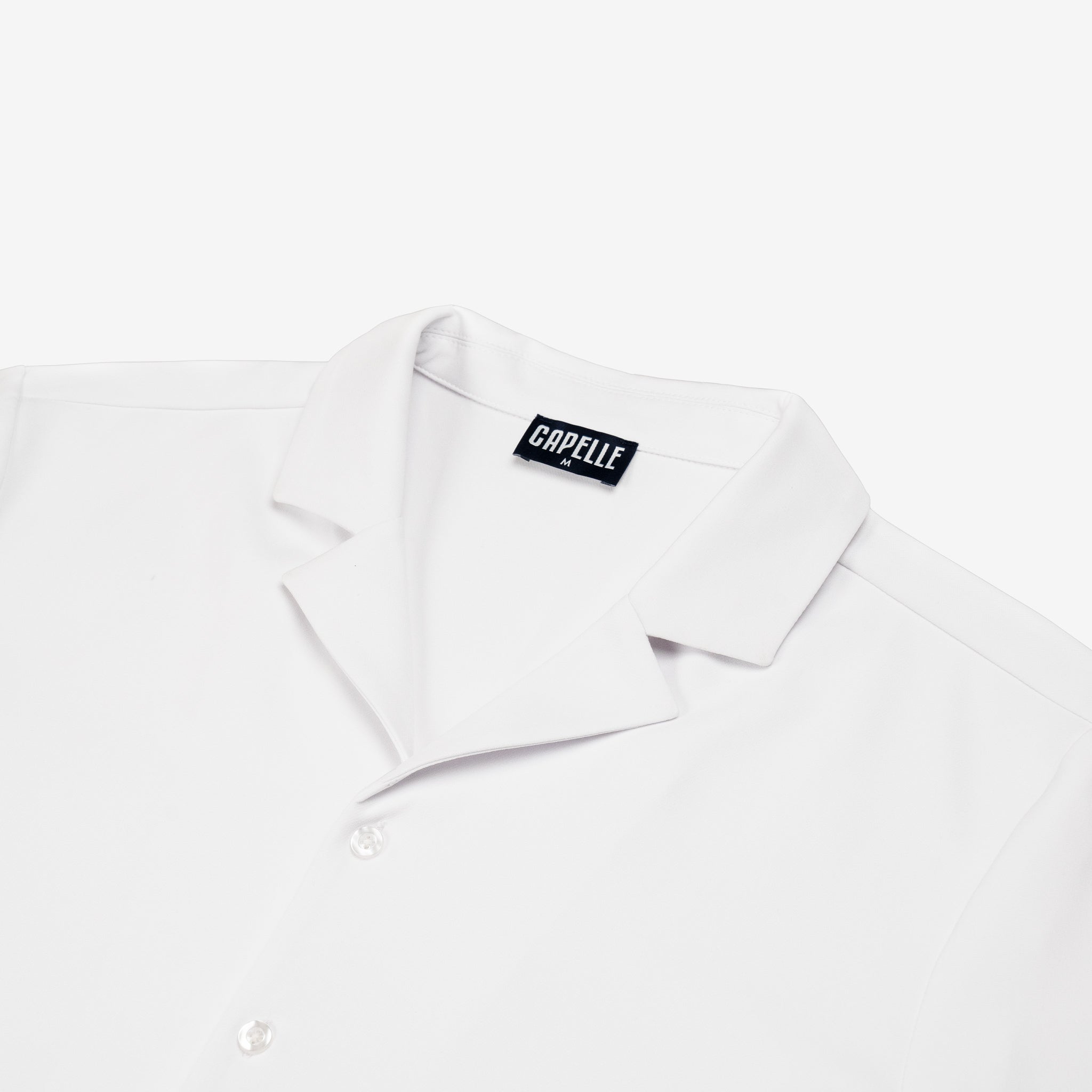 White dress shirt with a visible brand label on a white background