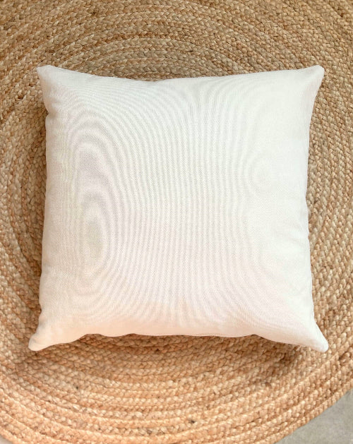 White pillow on a woven jute mat