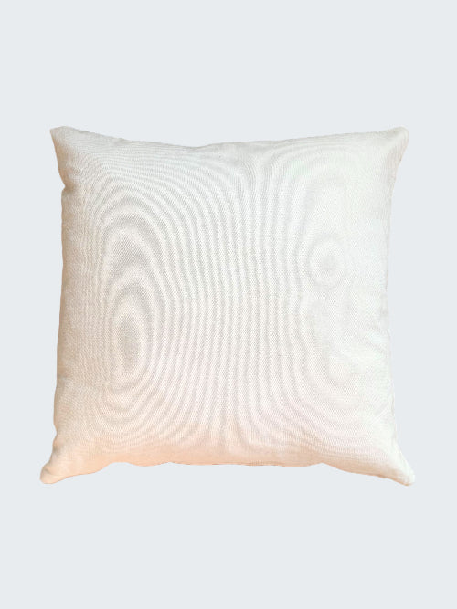 White pillow on a woven mat
