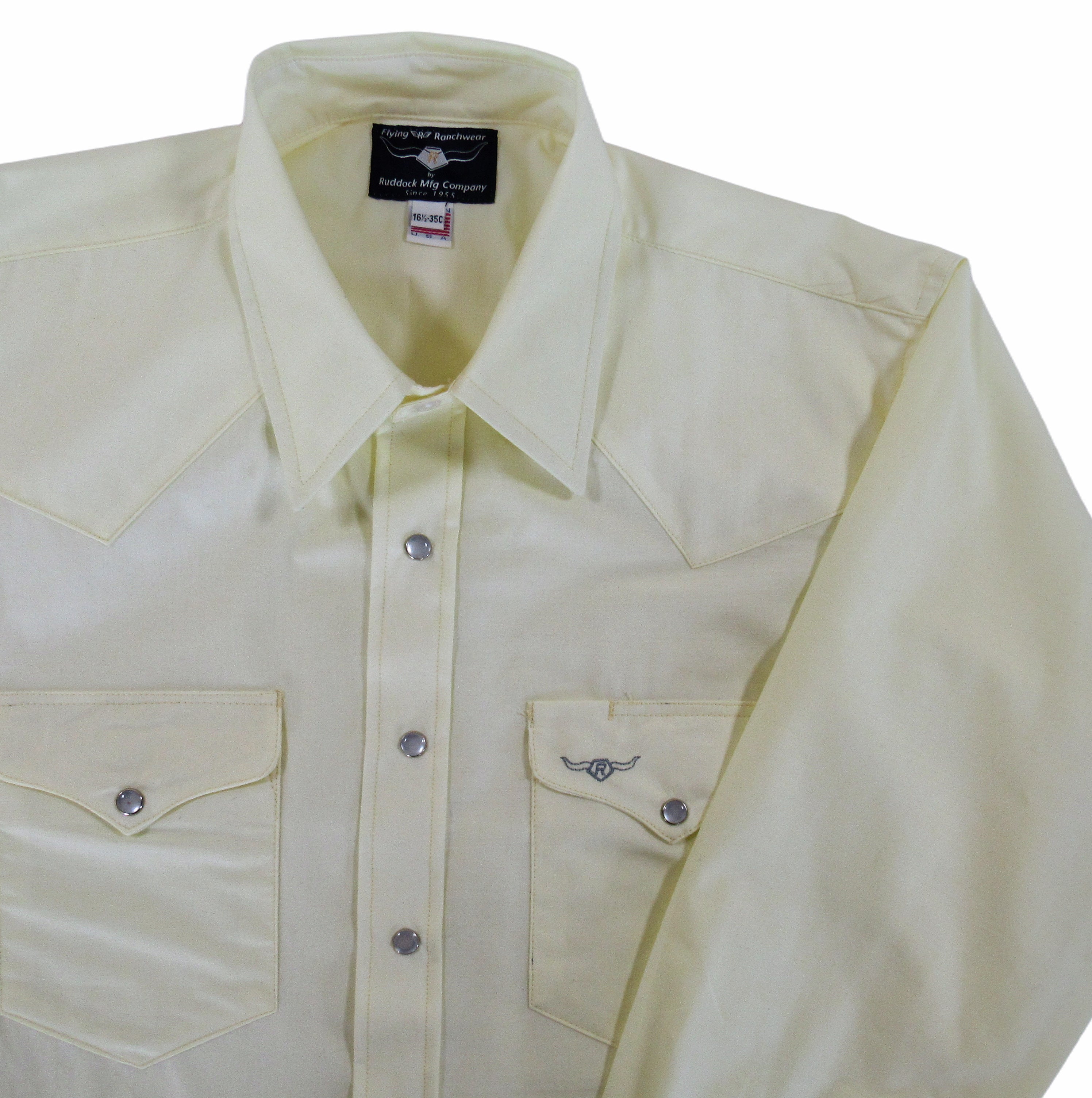 Light-colored shirt with button details on a white background
