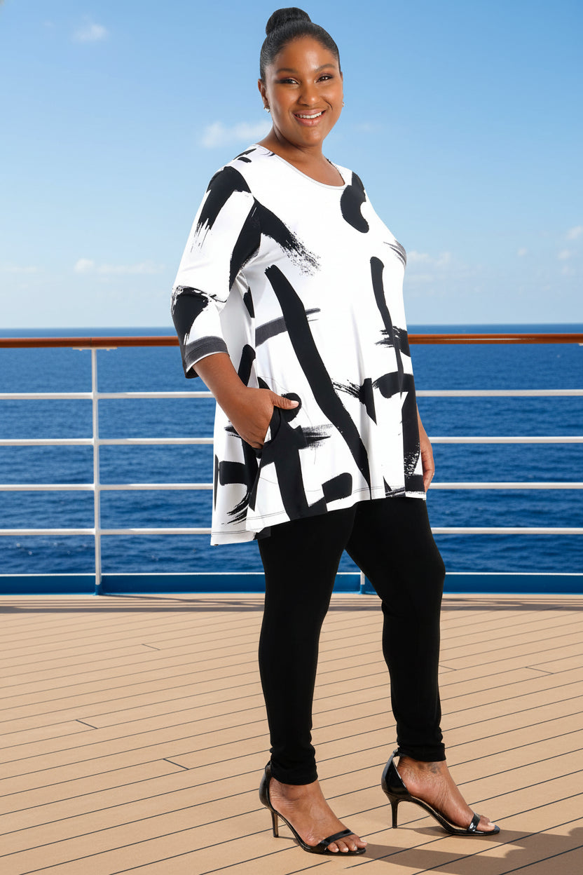 Woman wearing a black and white abstract patterned dress on a white background