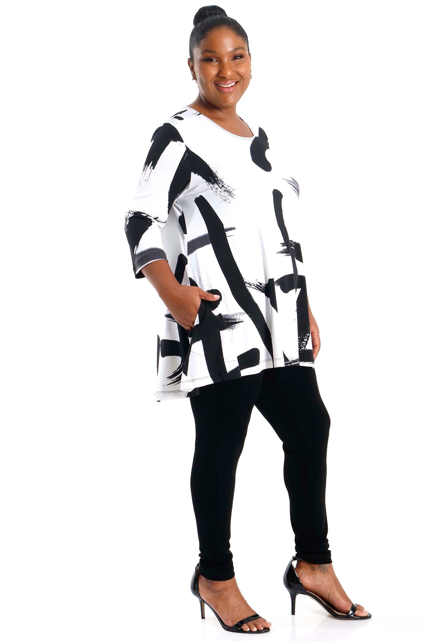 Woman wearing a black and white abstract patterned dress on a white background